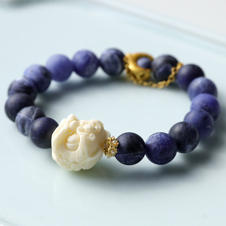 Buddha Stones Sodalite Ivory Fruit Dancing Lion Crescent Moon Harmony Bracelet